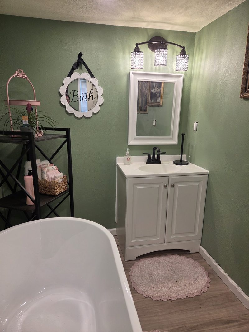 Remodeled bathroom with new vanity, flooring, and paint